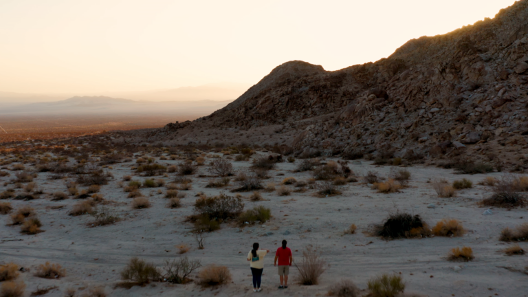 Father and daughter Sean and Gina Milanovich walk in the Mojave Desert